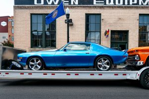 Vibrant blue classic car on a trailer against an urban backdrop in Bristol, Tennessee.